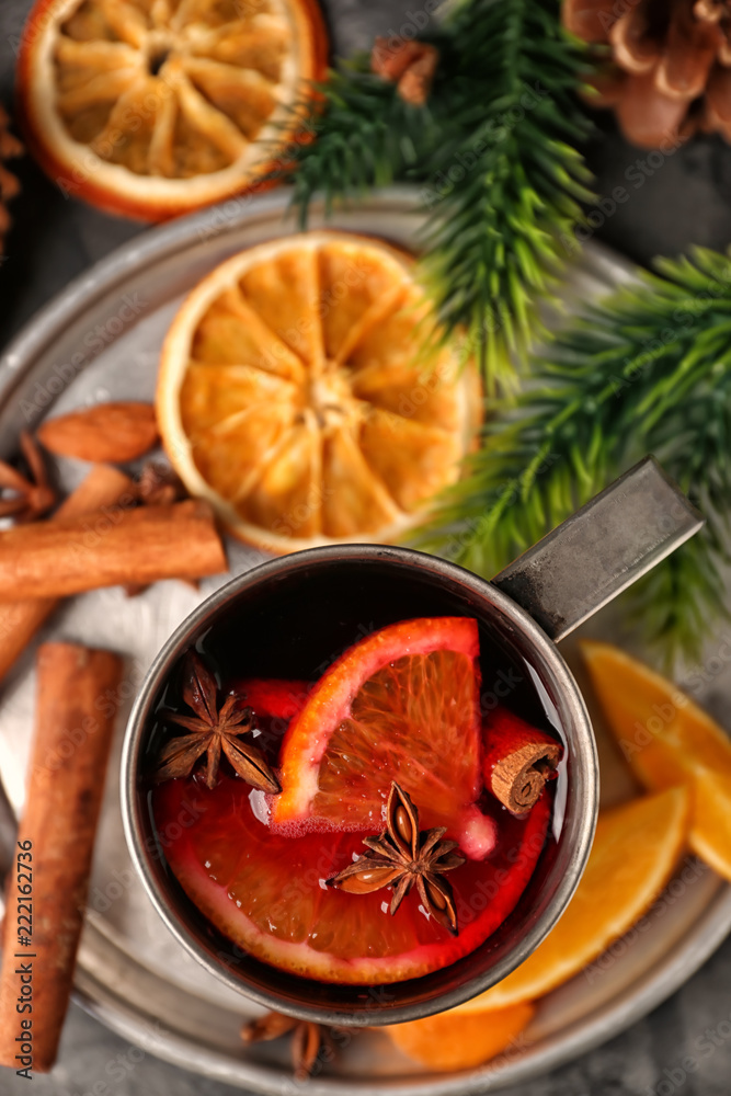 Metal cup of delicious mulled wine on tray Metal cup of delicious mulled wine on tray
