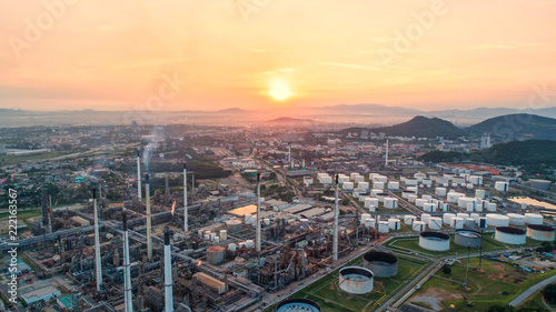 Industrial view at oil refinery plant form industry zone with sunrise and cloudy sky.Oil refinery and Petrochemical plant at dusk Thailand. Aerial view