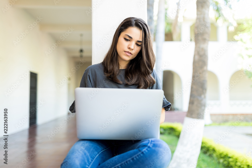 Female Keyboarding On Laptop While Sitting At Campus Female Keyboarding On Laptop While Sitting At Campus