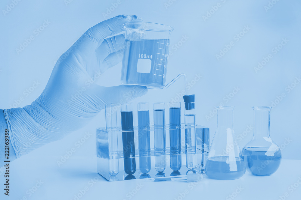 Laboratory glassware or test tube in hand for research. Laboratory glassware or test tube in hand for research.