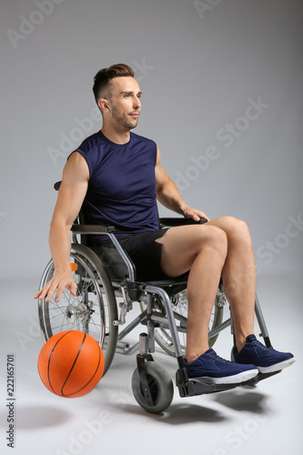 Young basketball player sit...