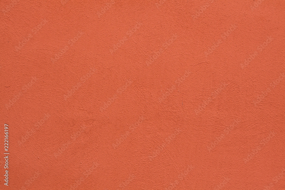 Naklejka premium Orange painted stucco wall. Background texture