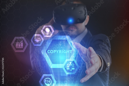 The concept of business, technology, the Internet and the network. A young entrepreneur working on a virtual screen of the future and sees the inscription: Copyright