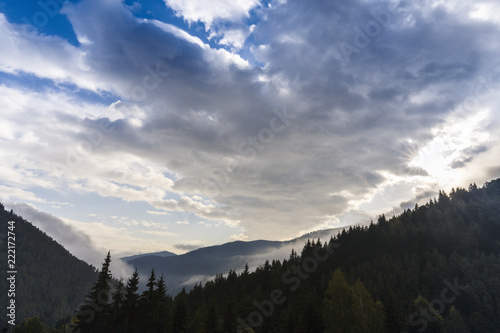 Beautiful  winter scenery in the mountains, with fresh snow, and mist, on a bright sunny day