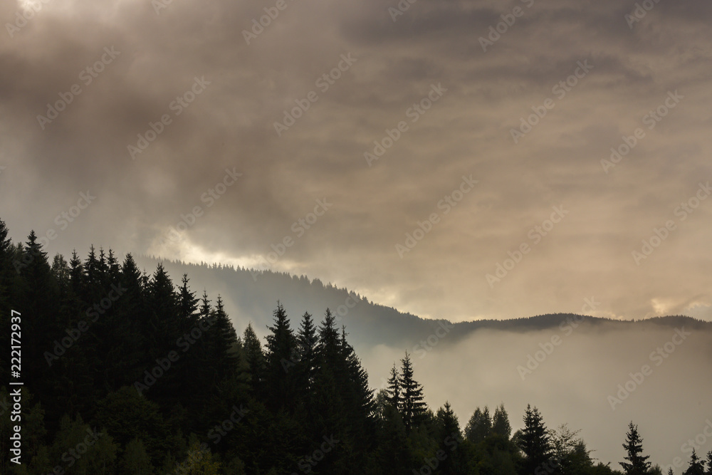Summer mountain scenery with mist clouds, at sunset Summer mountain scenery with mist clouds, at sunset