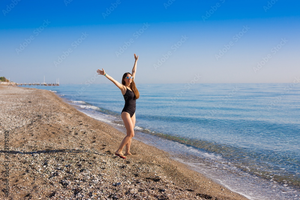 Turkey. Woman in sea, black swimsuit, sunglasses, fun