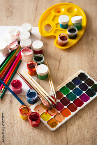 Watercolor Pallet, Oil Paints, Brushes Set and Wooden Color Pencils for Painting, on Wooden background, Close up..