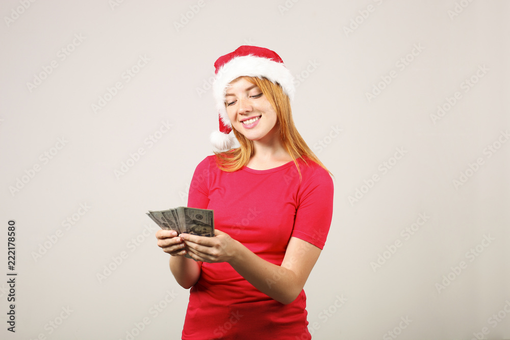 Money as a Christmas present concept. Portrait of happy young redheaded woman holding bunch of one hundred dollar bills that she received as New Year gift. Close up, copy space, background. Money as a Christmas present concept. Portrait of happy young redheaded woman holding bunch of one hundred dollar bills that she received as New Year gift. Close up, copy space, background.