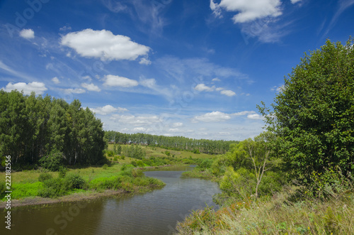 Sunny summer landscape with river green hills and beautiful clouds in blue sky.Tula region Russia.