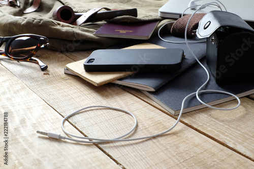Top view of traveler's accessories, essential explorer items, smartphone computer