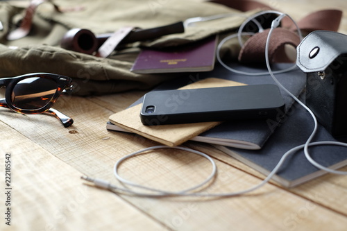Top view of traveler's accessories, essential explorer items, smartphone headphones