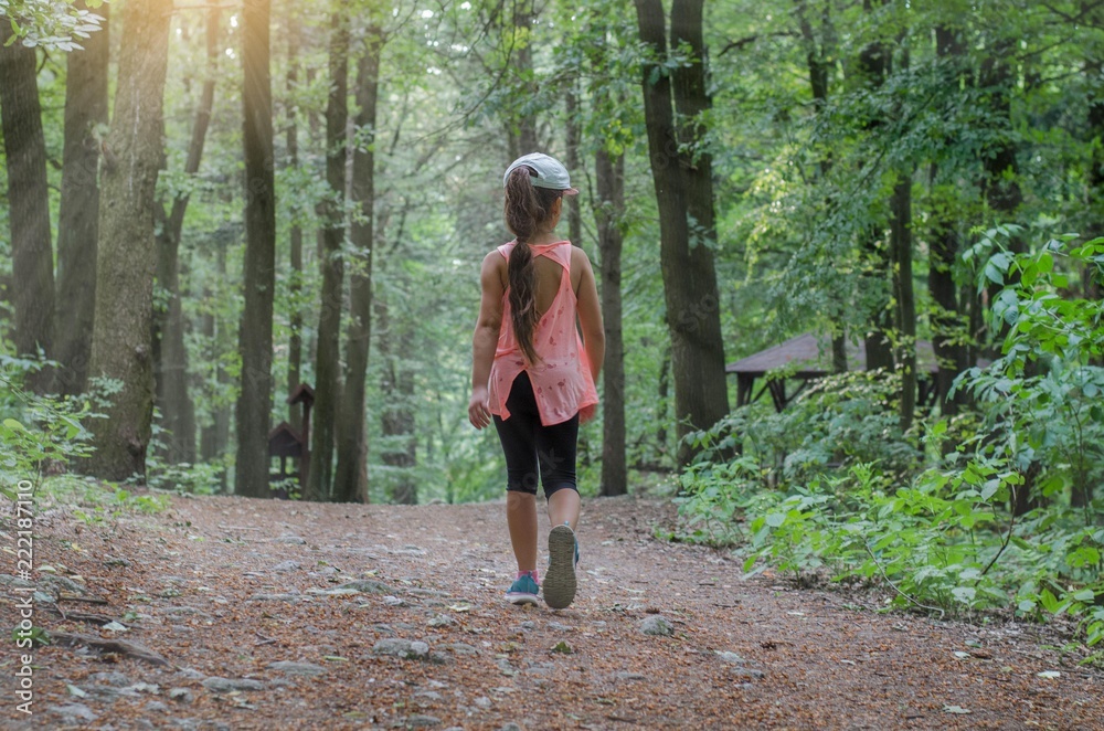 Little girl walking through the forest Little girl walking through the forest