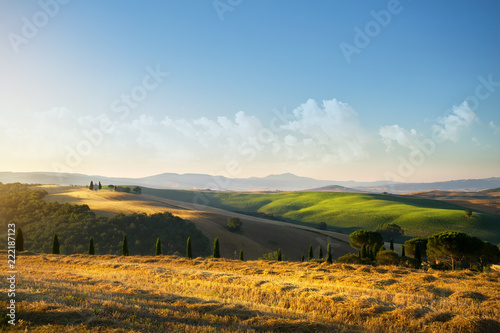 Fototapeta Naklejka Na Ścianę i Meble -  typical Tuscany countryside landscape; sunset over rolling hills and Tuscany village