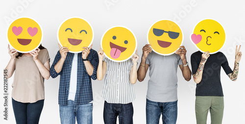 Diverse people holding happy emoticons photo