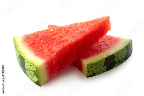 Two lying triangles of seedless watermelon isolated on white.