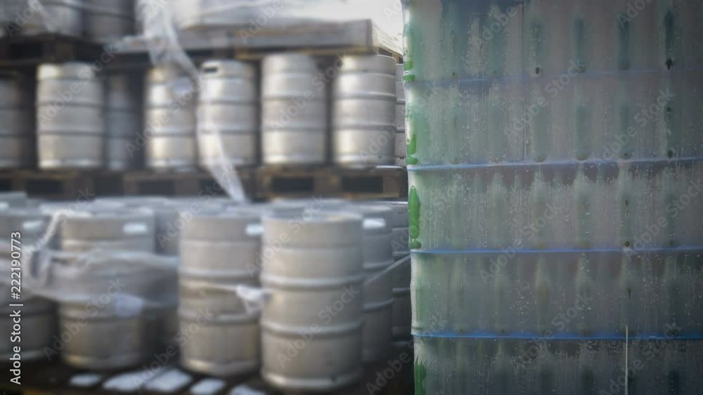 Packed bottles of beer and barrels and at the beer factory Packed bottles of beer and barrels and at the beer factory