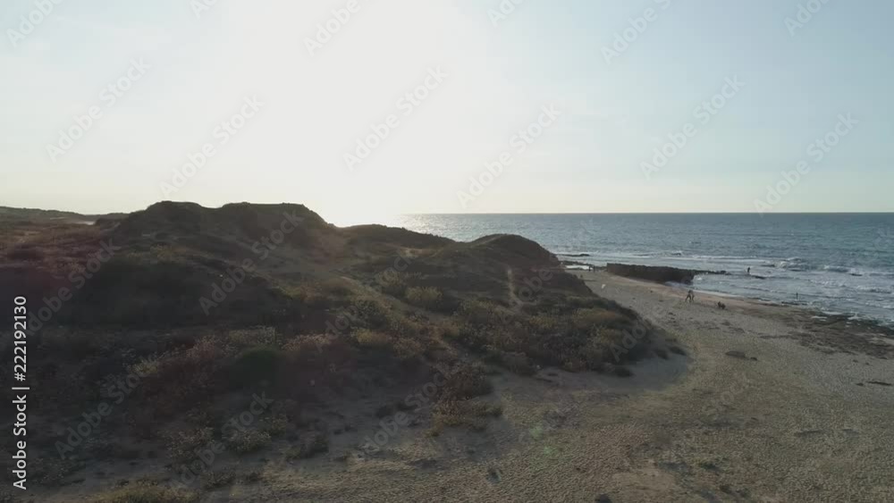 Aerial drone high shot above a cliff. View Directly Above Rocks, Surf And Cliff at beach shore Aerial drone high shot above a cliff. View Directly Above Rocks, Surf And Cliff at beach shore