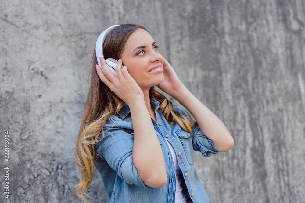 Side profile close up view portrait of  attractive beautiful cute lovely pretty cheerful excited joyful delightful rejoicing lady listening to favorite track tune isolated on gray concrete background