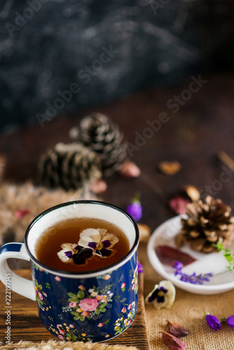 Herbal tea: pansies, petals, edible flowers, on a light background