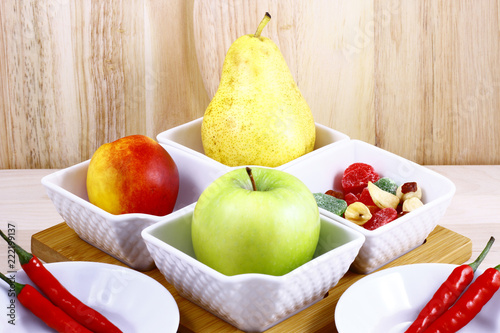 Beautifully laid out fresh summer fruits on a background of cutting boards photo