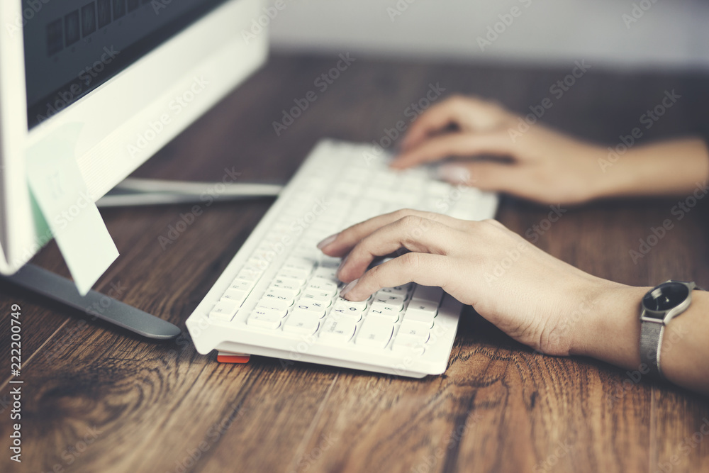 female hand typing on desktop computer keyboard female hand typing on desktop computer keyboard