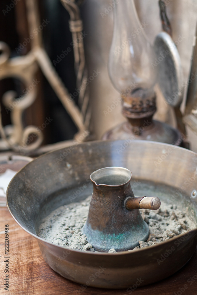 Traditional turkish coffee in cezve prepared on hot sand.