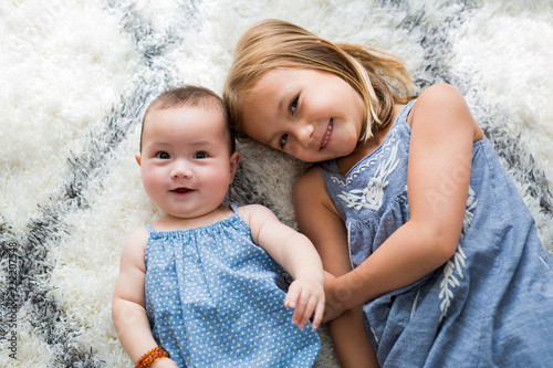 Sisters Smiling Sitting photo