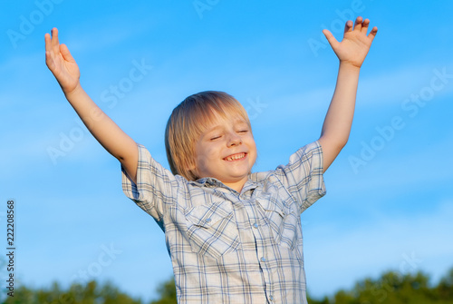 happy little boy on the sky background
