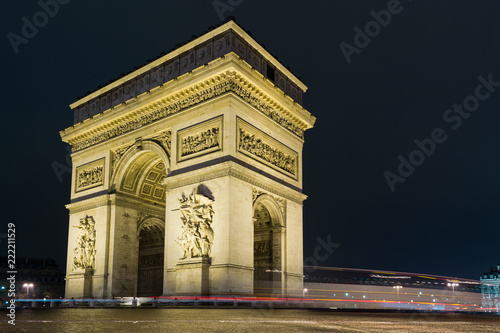 Street view of Arc de Triomphe (Triumphal Arch) in Chaps Elysees at night, Paris, France. © marcodotto