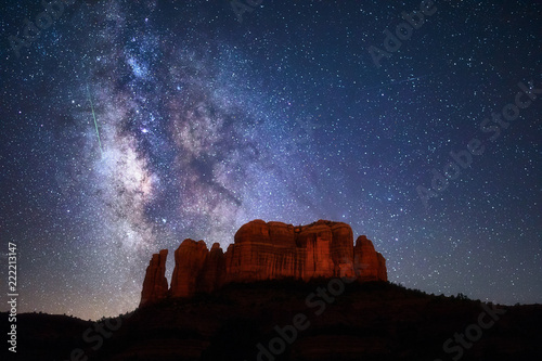 A meteor streaks through the Milky Way above Cathedral Rock in Sedona, Arizona.