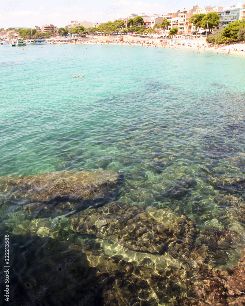 View of clear blue water over rocks and reefs in the Mediterranean. At Porto Cristo beach, Mallorca