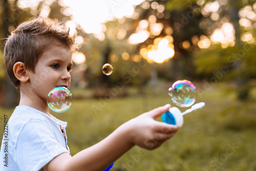 Boy playing with soap balloons outdoor