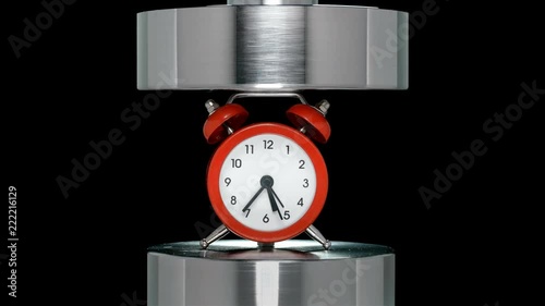 crash test alarm clock, hours under hydraulic press, close-up