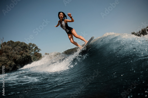 Girl riding on the wakeboard on the lake © fesenko