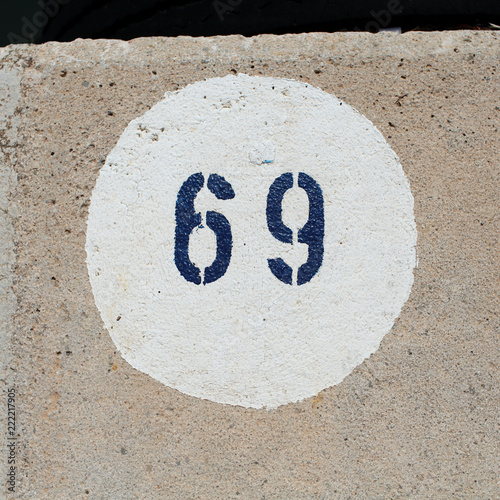 Number 69 painted on a concrete floor