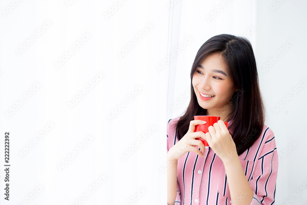 Beautiful of portrait young asian woman with drink a cup of coffee standing curtain window background in bedroom, girl relax in morning at home, lifestyle concept. Beautiful of portrait young asian woman with drink a cup of coffee standing curtain window background in bedroom, girl relax in morning at home, lifestyle concept.