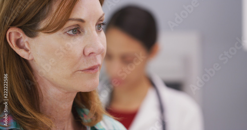 Canvas Print Closeup portrait of caucasian middle aged patient sitting in medical clinic waiting to consult with doctor