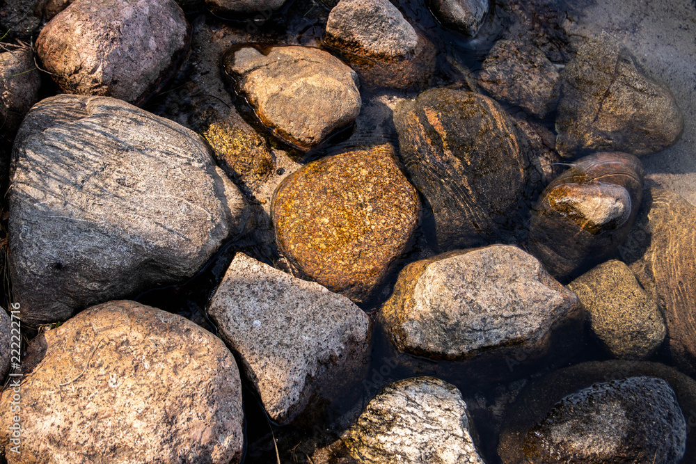 brown gray stones and sand in clear water. brown gray stones and sand in clear water.