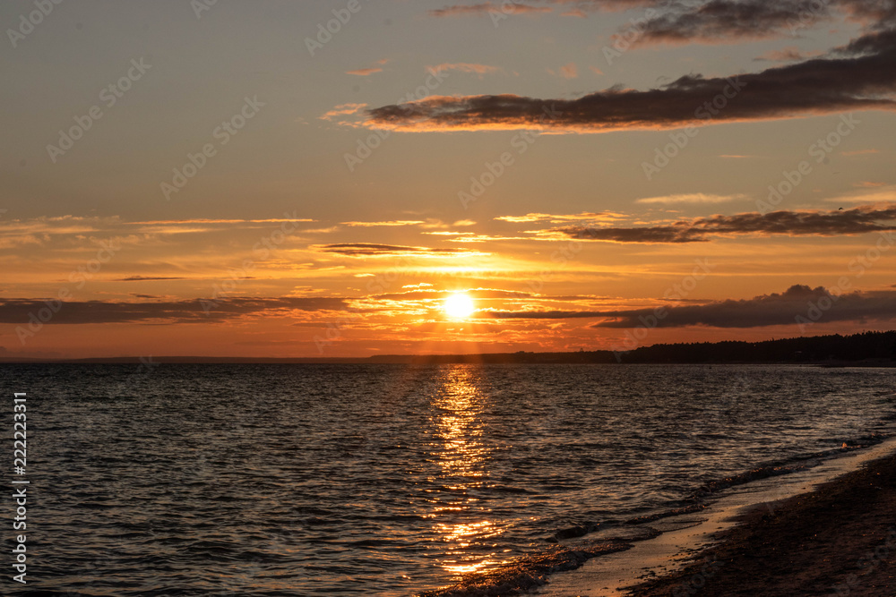 yellow red sunset over the sea, horizon, beach, dark clouds yellow red sunset over the sea, horizon, beach, dark clouds
