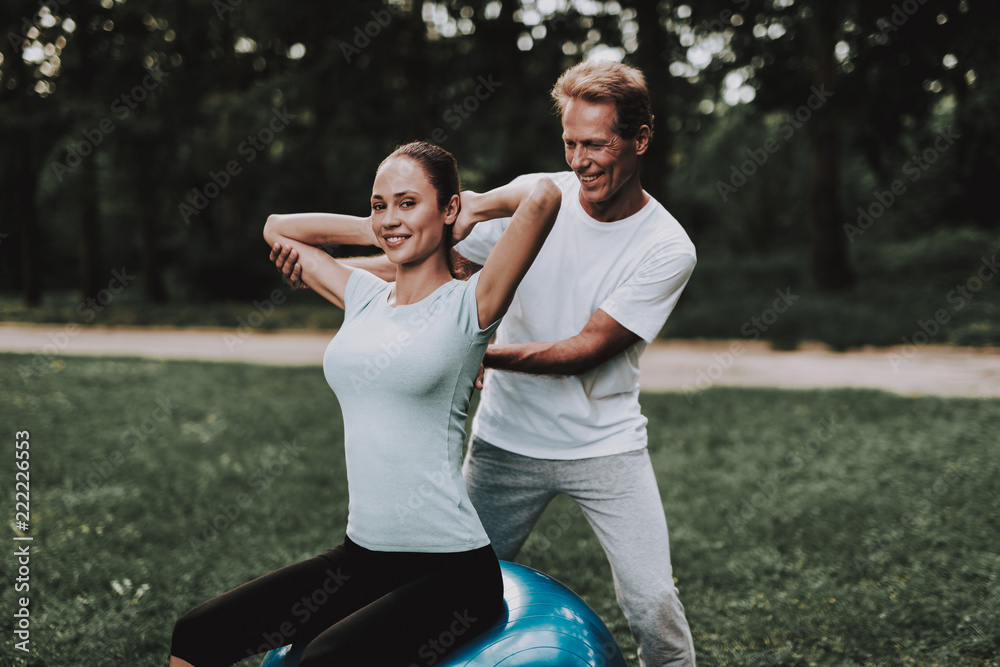 Young Couple in Sportswear Doing Yoga in Park Young Couple in Sportswear Doing Yoga in Park