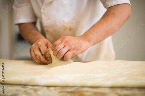 Baker hands kneading dough bread