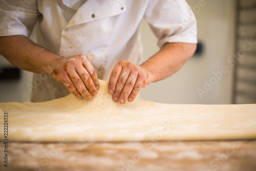 Baker hands kneading dough white baking