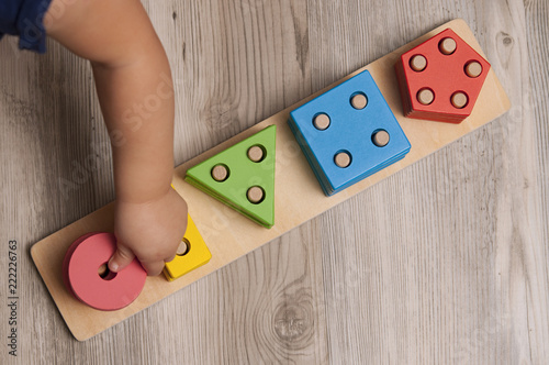 Toddler Playing with wooden toys