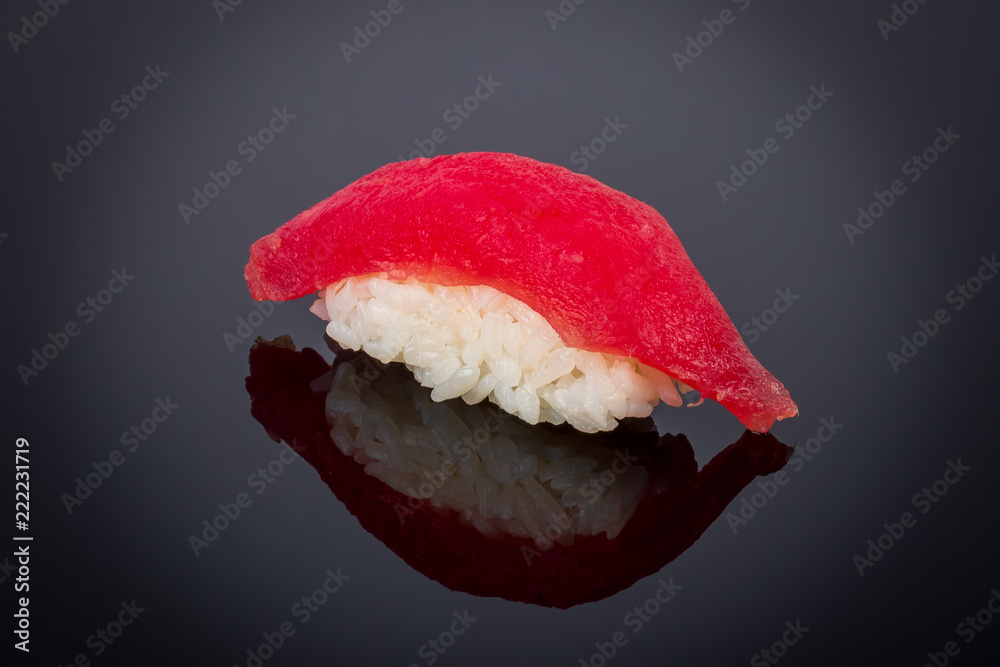 sushi tuna on black with reflection