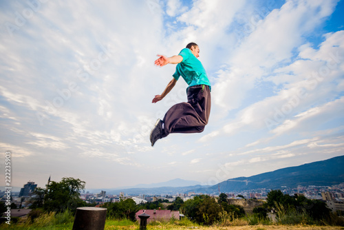 Young parkour man jumping in nature