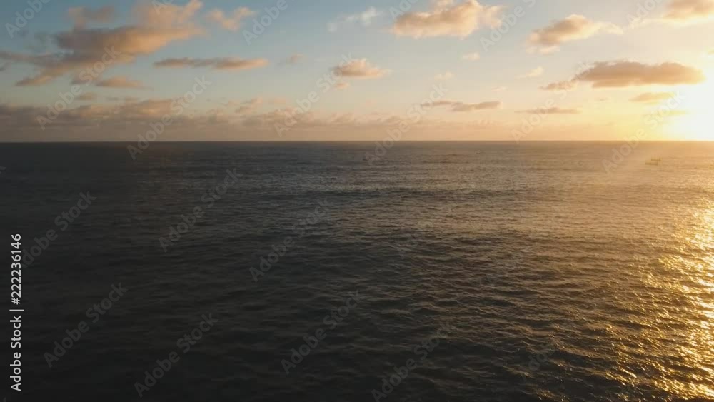 Aerial view orange sunset over the sea, the ocean. Flying over the blue ocean with blue water, sky. Bali,Indonesia.4K video. Travel concept. Aerial footage Aerial view orange sunset over the sea, the ocean. Flying over the blue ocean with blue water, sky. Bali,Indonesia.4K video. Travel concept. Aerial footage