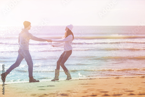 Loving young couple on a beach at autumn sunny day