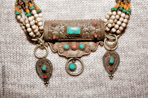 Jewelry necklace made of Tibetan silver on burlap background 