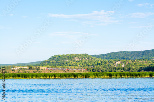 Train on the railway on the bank of the river Sok in the village of Malaya Tsarevschina Samara region Russia photo