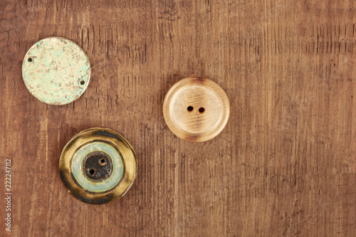 An overhead photo of three vintage buttons, shot from above with copy space